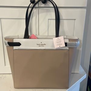 Brand new Kate Spade tan and white laptop bag. Never been used.